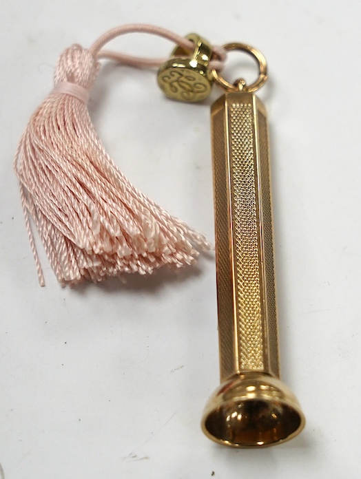 A modern engine turned 9ct gold cigar piercer, overall 67mm, gross weight 15.8 grams. Condition - fair